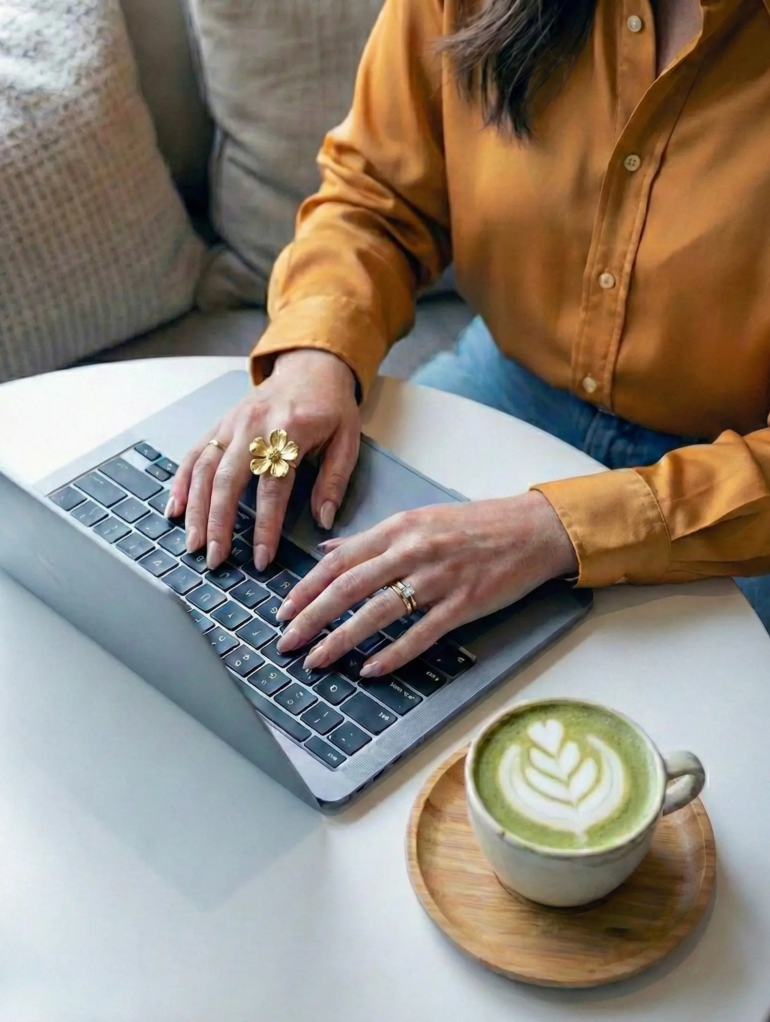 Woman working on laptop with coffee